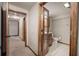 A bathroom featuring a toilet and a vanity with paneled wood doors and an adjacent hallway at 191 White Oak Church Rd, Dallas, GA 30157