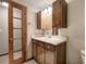 Bathroom featuring a single sink vanity with paneled wood doors and a mirror at 191 White Oak Church Rd, Dallas, GA 30157