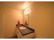Bathroom features a single sink vanity with a dark countertop and an unframed mirror at 191 White Oak Church Rd, Dallas, GA 30157