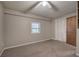 Bedroom with carpet, built-in shelves, and closet at 191 White Oak Church Rd, Dallas, GA 30157