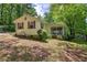 Beautiful house with porch and shuttered windows, set in a lush, wooded landscape at 191 White Oak Church Rd, Dallas, GA 30157