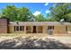 Charming single-story home with a covered front porch, brick chimney, and gravel driveway at 191 White Oak Church Rd, Dallas, GA 30157