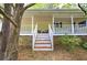 Inviting covered front porch with seating, offering a relaxing outdoor space at 191 White Oak Church Rd, Dallas, GA 30157