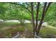 Landscaped front yard with mature tree, green lawn and stone walkway at 191 White Oak Church Rd, Dallas, GA 30157