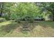 Charming home with lush lawn, mature trees, and stone steps leading to the front porch at 191 White Oak Church Rd, Dallas, GA 30157