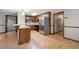 Kitchen featuring stainless steel appliances, and a breakfast bar leading into the living room at 191 White Oak Church Rd, Dallas, GA 30157