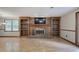 Living room with brick fireplace, built-in shelving, and a mounted television at 191 White Oak Church Rd, Dallas, GA 30157