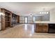 Open-concept living room featuring a brick fireplace, built-in shelving, and light wood floors at 191 White Oak Church Rd, Dallas, GA 30157