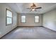 Spacious main bedroom has tray ceiling, carpet, and large windows at 191 White Oak Church Rd, Dallas, GA 30157