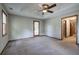 Large main bedroom with tray ceiling, ceiling fan and carpet at 191 White Oak Church Rd, Dallas, GA 30157