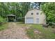 Exterior featuring a barn with a garage door and an outbuilding covered area at 191 White Oak Church Rd, Dallas, GA 30157
