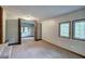 A multi purpose room with carpeted flooring, windows, and bi-fold doors to another room at 191 White Oak Church Rd, Dallas, GA 30157