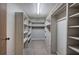 Spacious walk-in closet featuring carpeted floors and white shelving for ample storage at 191 White Oak Church Rd, Dallas, GA 30157