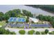 Aerial view of community with tennis courts, pool, and lake access; great for recreation and relaxation at 2258 Bright Water Dr, Snellville, GA 30078
