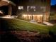 View of the landscaped backyard featuring a covered patio illuminated with string lights at night at 2258 Bright Water Dr, Snellville, GA 30078