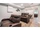 Finished basement with leather recliners, custom millwork, and plank flooring at 2258 Bright Water Dr, Snellville, GA 30078