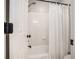 Bathroom features a white shower with a white shower curtain and a white tiled wall at 2258 Bright Water Dr, Snellville, GA 30078