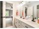 Double sink bathroom vanity with modern fixtures, granite countertops, and gray walls, with a view to the bedroom at 2258 Bright Water Dr, Snellville, GA 30078