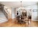 Open-concept dining room, featuring wooden table, flooring, and view of the living area at 2258 Bright Water Dr, Snellville, GA 30078