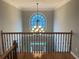 Foyer staircase featuring detailed railing and a unique arched window with elegant lighting fixture at 2258 Bright Water Dr, Snellville, GA 30078