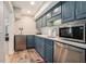 Finished basement kitchenette with stainless steel appliances, custom cabinets, and white countertops at 2258 Bright Water Dr, Snellville, GA 30078