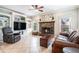 Cozy living room with brick fireplace, custom built-ins and plush leather seating at 2258 Bright Water Dr, Snellville, GA 30078