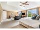 Spacious main bedroom with tray ceiling, sitting area, and large windows with a view at 2258 Bright Water Dr, Snellville, GA 30078