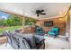 Covered brick patio with outdoor seating, ceiling fan and a mounted TV at 2258 Bright Water Dr, Snellville, GA 30078