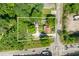 An aerial view of a property with a large lot, mature trees, and a house with a driveway at 2667 Peyton Nw Rd, Atlanta, GA 30318