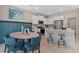 Eat-in kitchen boasts white cabinets, stainless steel appliances, and a breakfast bar with stool seating at 82 Hydrangea Cir, Fairburn, GA 30213