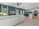 Open-concept living room with modern decor, a ceiling fan, and seamless flow to the kitchen at 82 Hydrangea Cir, Fairburn, GA 30213