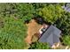 Aerial view of a home's roof and backyard, surrounded by dense trees, offering privacy and a serene setting at 902 Laurel Crest Dr, Woodstock, GA 30189