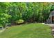 Large backyard with a well-maintained lawn, trees, and outdoor living areas at 902 Laurel Crest Dr, Woodstock, GA 30189