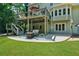 Relaxing backyard with a patio, fire pit, and an elevated deck with seating area perfect for outdoor enjoyment at 902 Laurel Crest Dr, Woodstock, GA 30189
