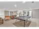 Open basement featuring a ping pong table, kitchenette, and comfortable seating at 902 Laurel Crest Dr, Woodstock, GA 30189