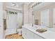 Neutral bathroom featuring a shower-tub combination and a large white vanity at 902 Laurel Crest Dr, Woodstock, GA 30189