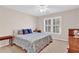 Comfortable bedroom with natural light, neutral walls, and carpet flooring at 902 Laurel Crest Dr, Woodstock, GA 30189