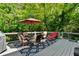 Inviting deck furnished with an umbrella-covered dining table, chairs, and a chaise lounge at 902 Laurel Crest Dr, Woodstock, GA 30189