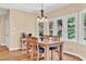 Dining area with wood table, seating for six, many windows and hardwood floors at 902 Laurel Crest Dr, Woodstock, GA 30189