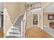 Bright foyer with hardwood floors, carpeted staircase, and views into the formal rooms at 902 Laurel Crest Dr, Woodstock, GA 30189