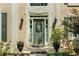 Close-up of a charming front door flanked by planters and classic sconces at 902 Laurel Crest Dr, Woodstock, GA 30189