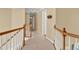 Upstairs hallway with wood and white railing overlooking the entry at 902 Laurel Crest Dr, Woodstock, GA 30189