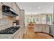 Kitchen featuring a gas range, stainless appliances, granite countertops, and hardwood floors at 902 Laurel Crest Dr, Woodstock, GA 30189
