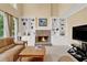 Comfortable living room featuring a stone fireplace flanked by custom built-in shelving at 902 Laurel Crest Dr, Woodstock, GA 30189