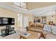 Open concept living room with large TV, leather sofa, staircase and view of the kitchen at 902 Laurel Crest Dr, Woodstock, GA 30189