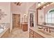 Spacious main bathroom with dual vanities, tiled floor, walk in shower and soaking tub at 902 Laurel Crest Dr, Woodstock, GA 30189