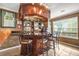 Custom bar area with seating, dark wood finishes, and custom lighting at 160 Oak Manor Dr, Covington, GA 30016