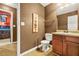 Bathroom featuring a wood vanity, single sink, toilet, and framed mirror at 160 Oak Manor Dr, Covington, GA 30016