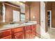 Bathroom featuring a double sink vanity with wood cabinets and a large mirror at 160 Oak Manor Dr, Covington, GA 30016