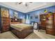 Cozy bedroom featuring blue walls, ceiling fan, and sports memorabilia decor at 160 Oak Manor Dr, Covington, GA 30016